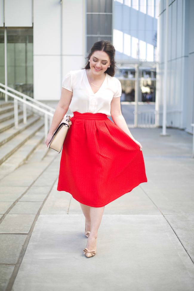 Valentine's Day, red midi skirt, white blouse, dainty gold jewelry, nude pumps with bow, blush bag, half up hairstyle