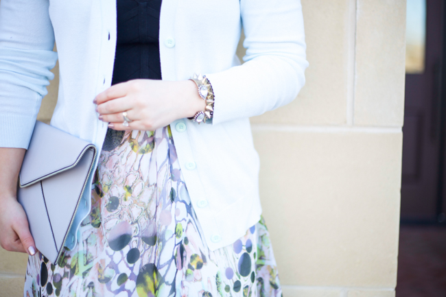 Mae Amor- floral Asher by Fab'rik skirt, black bandage crop top, light blue cardigan, Rebecca Minkoff Leo clutch, black ankle strap heels, Loren Hope